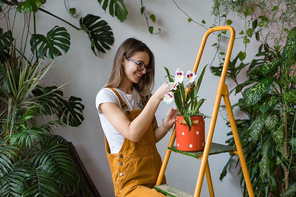 a women enjoying the health benefits of indoor plants
